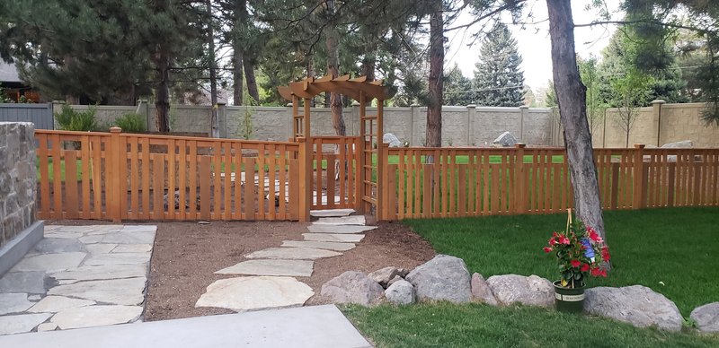 Cedar fence with arbor gate and stepping stone path
