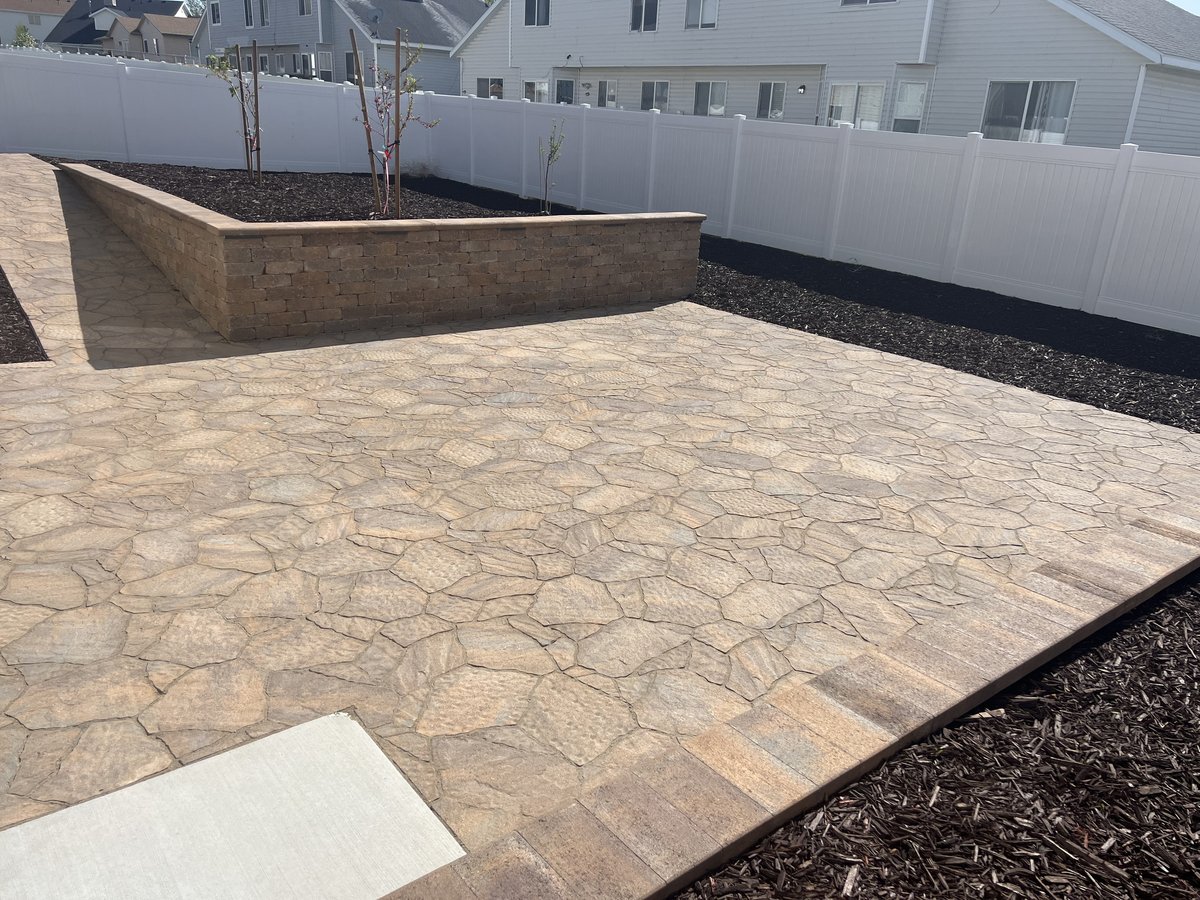 Stamped paver patio with block retaining wall