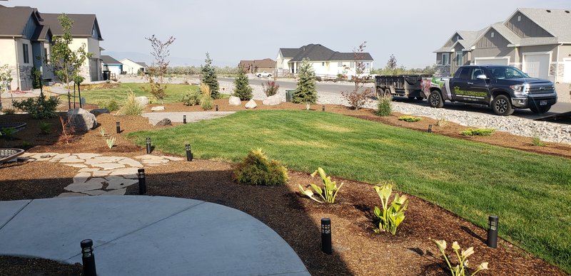 Full front yard landscaping with plantings and flagstone